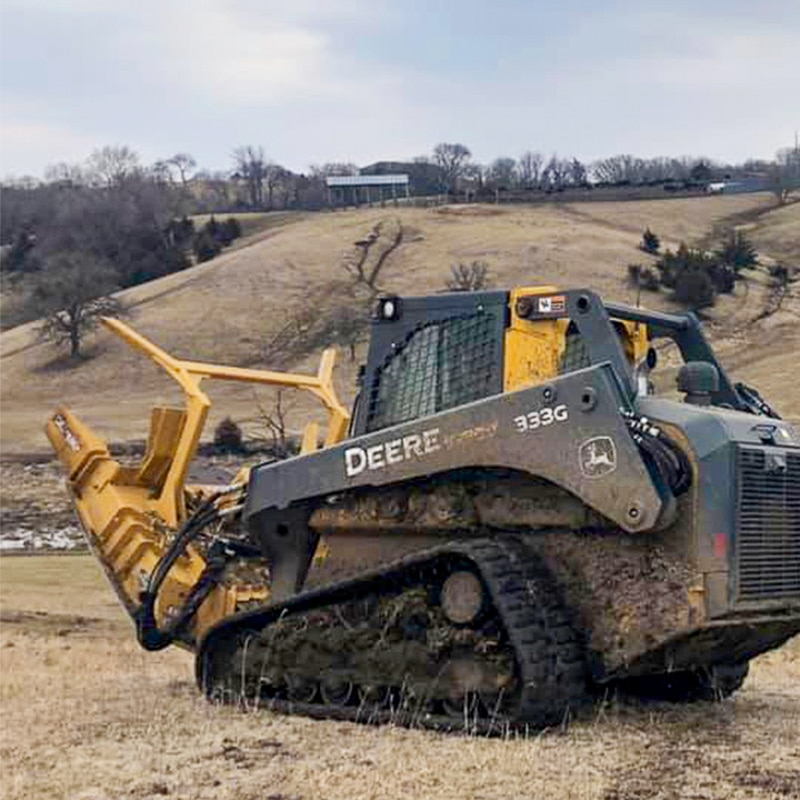 skid steer with a mulcher attached