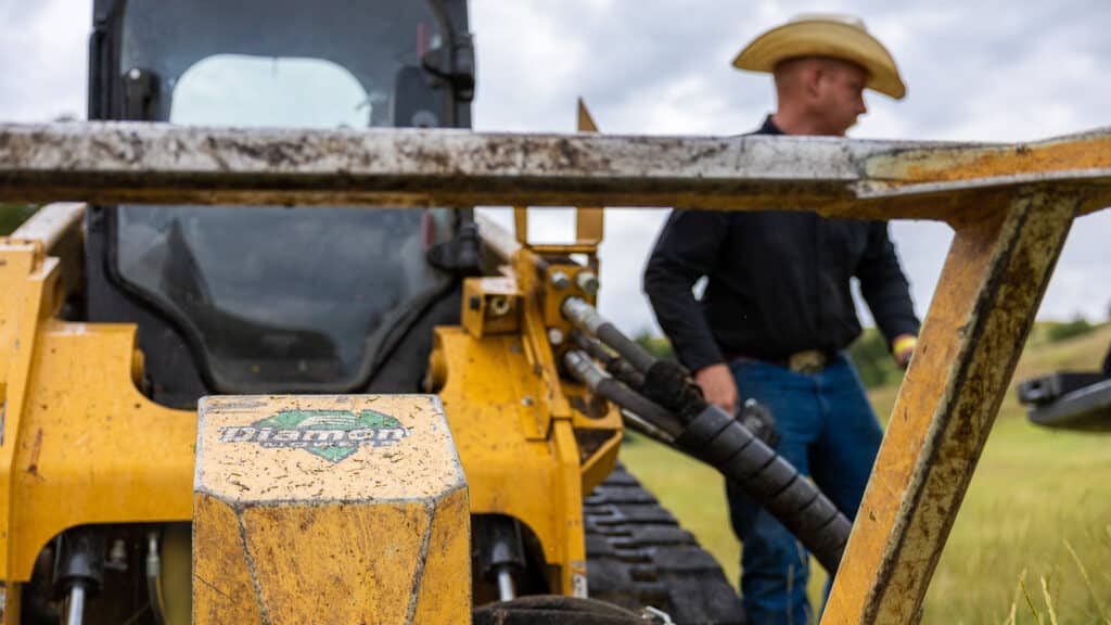 guy by skid steer disc mulcher