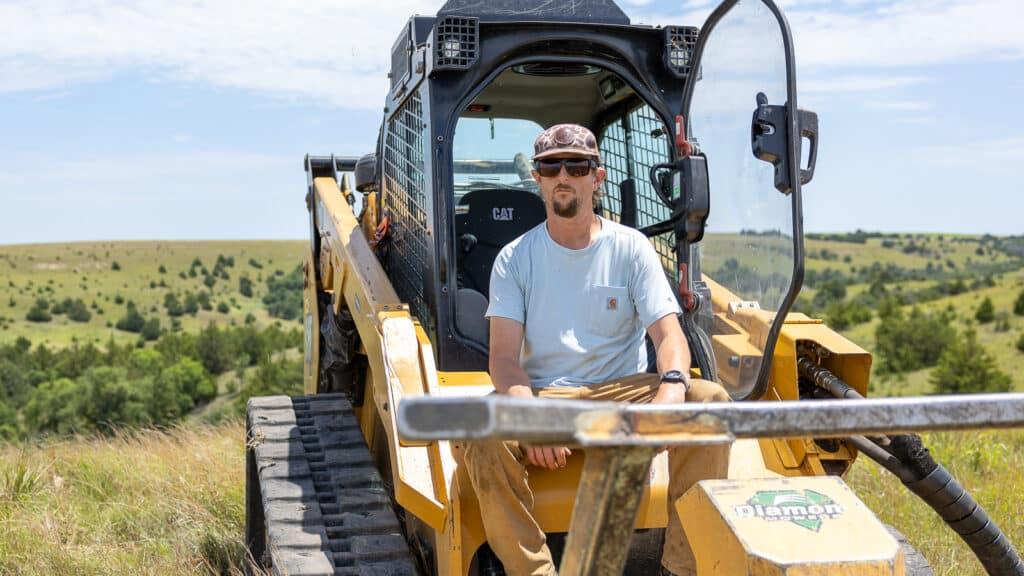 guy by skid steer disc mulcher