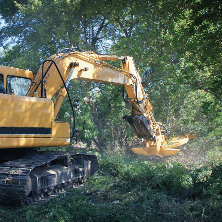 excavator with rotary mower attached