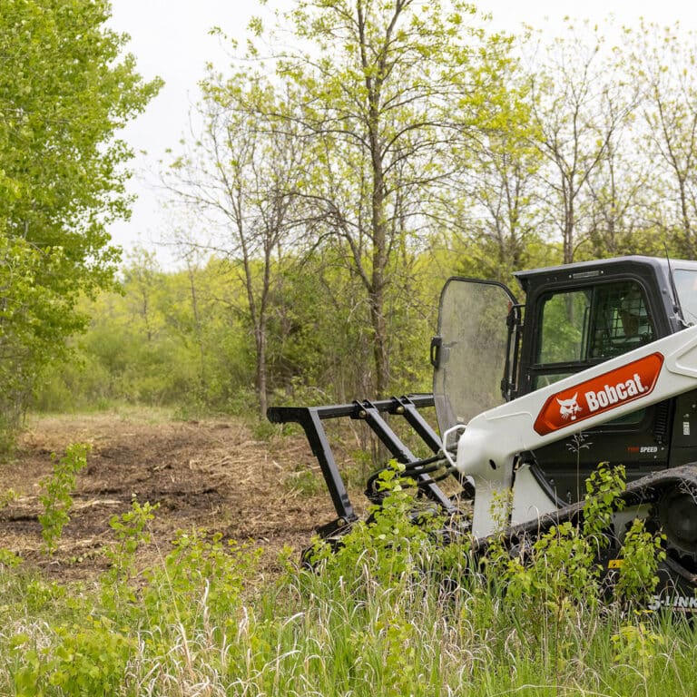 skid steer in the forest