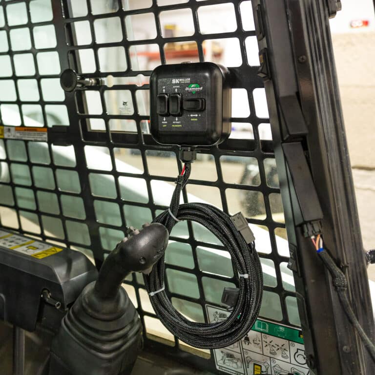 miller stump grinder control mounted in skid steer cab