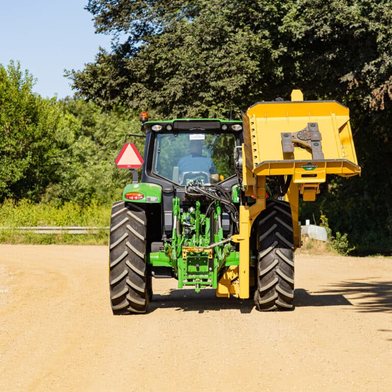 rear view of a tractor with a mid mount rotary mower attached